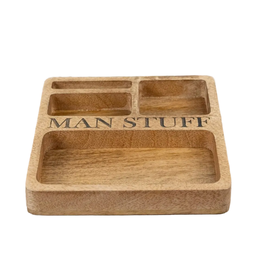 A rectangular wooden compartment tray engraved with the words 'MAN STUFF' in black lettering.