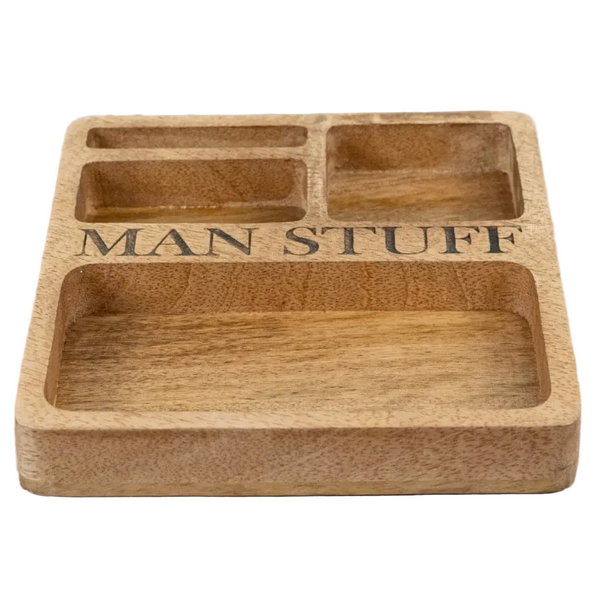A rectangular wooden compartment tray engraved with the words 'MAN STUFF' in black lettering.