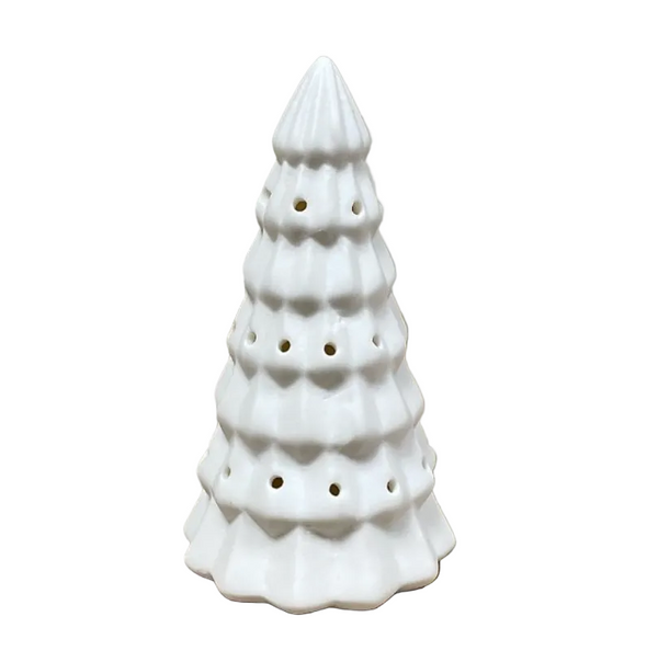 A small white ceramic Christmas tree-shaped candle holder or diffuser with perforated holes.