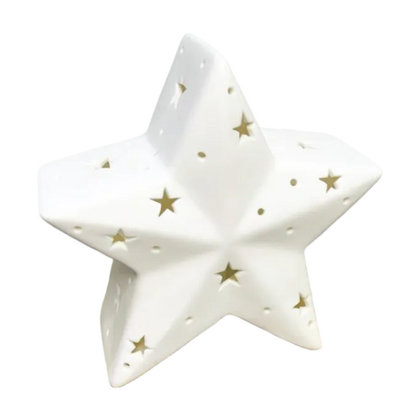 A white ceramic star-shaped candle holder with gold star cutouts.