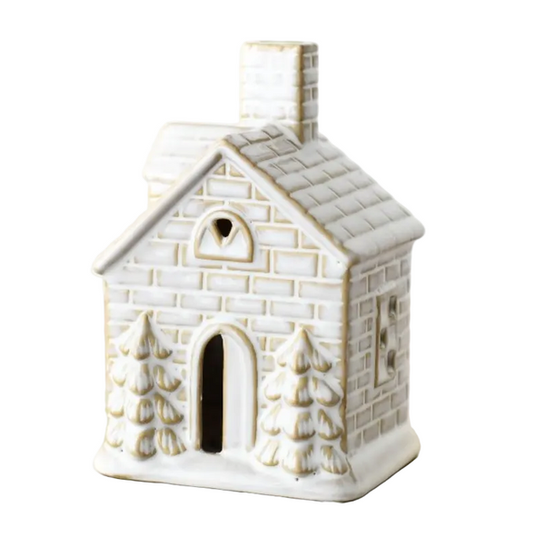 A small ceramic house-shaped candle holder or ornament with a textured off-white and beige brick-like pattern.