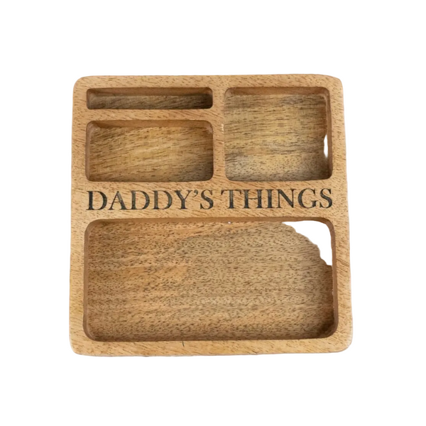 A square wooden tray with four compartments, featuring the engraved text 'DADDY'S THINGS' across the center.