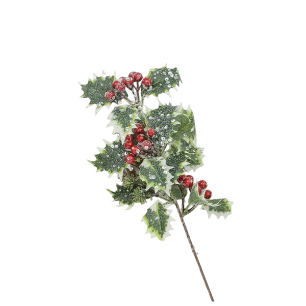 A single artificial holly branch with green leaves dusted with white faux snow and clusters of red berries, photographed on a plain light gray background.
