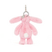 Pink plush bunny keychain on a white background