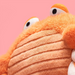 Close-up of a plush toy with a pink background