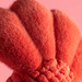 Close-up of a fluffy pink object with a soft texture on a pink background