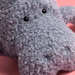 Close-up of a gray plush toy with black eyes.
