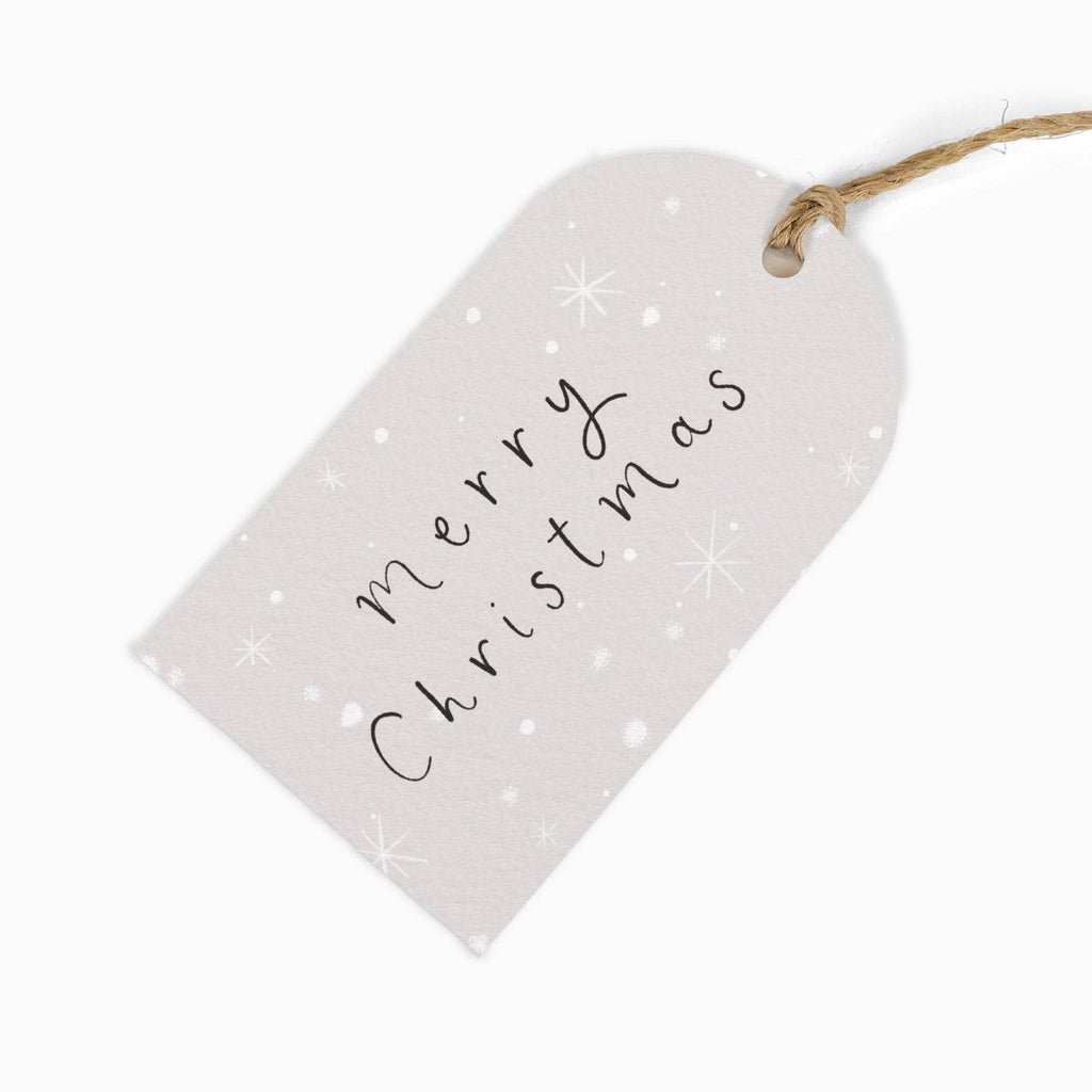 Heart-shaped white tag with 'Merry Christmas' text on a white background