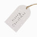 Heart-shaped white tag with 'Merry Christmas' text on a white background