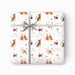 Gift wrapped in Christmas-themed paper with a gray ribbon on a white background