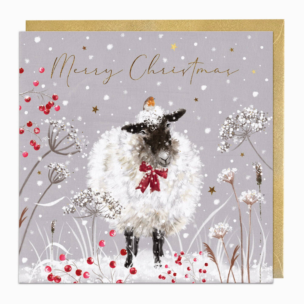 Christmas card with a sheep wearing a red bow, surrounded by flowers and berries on a gray background.