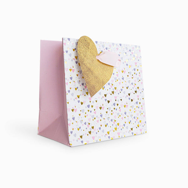 Greeting card with gold heart and colorful heart pattern on a white background
