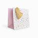 Greeting card with gold heart and colorful heart pattern on a white background