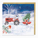 Christmas card with a red tractor pulling a trailer with a Christmas tree and presents through a snowy landscape.