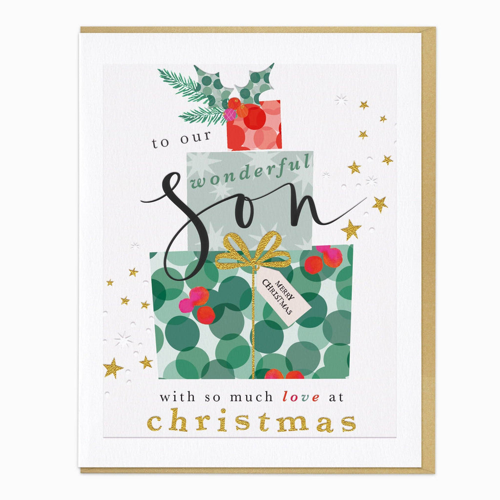 A square Christmas greeting card with a gold border, featuring an illustration of stacked gift boxes with green holly leaves, red berries, gold stars, and the text 'to our wonderful Son with so much love at Christmas'.