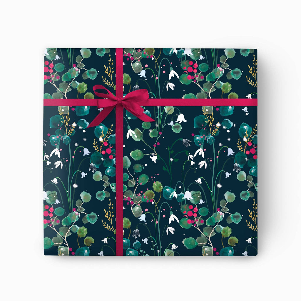 Gift box with floral design and pink ribbon on a white background