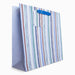 Striped gift bag with a blue handle on a white background