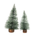 Two small artificial Christmas trees with white snow-like dusting, one tall and one short, both mounted on brown faux wood bases, shown on a plain white background.