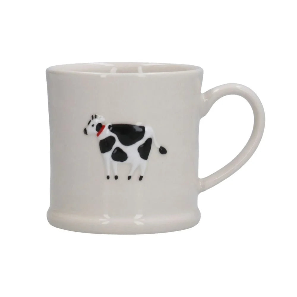 White mug with a black and white cow design on a white background