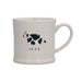 White mug with a black and white cow design on a white background