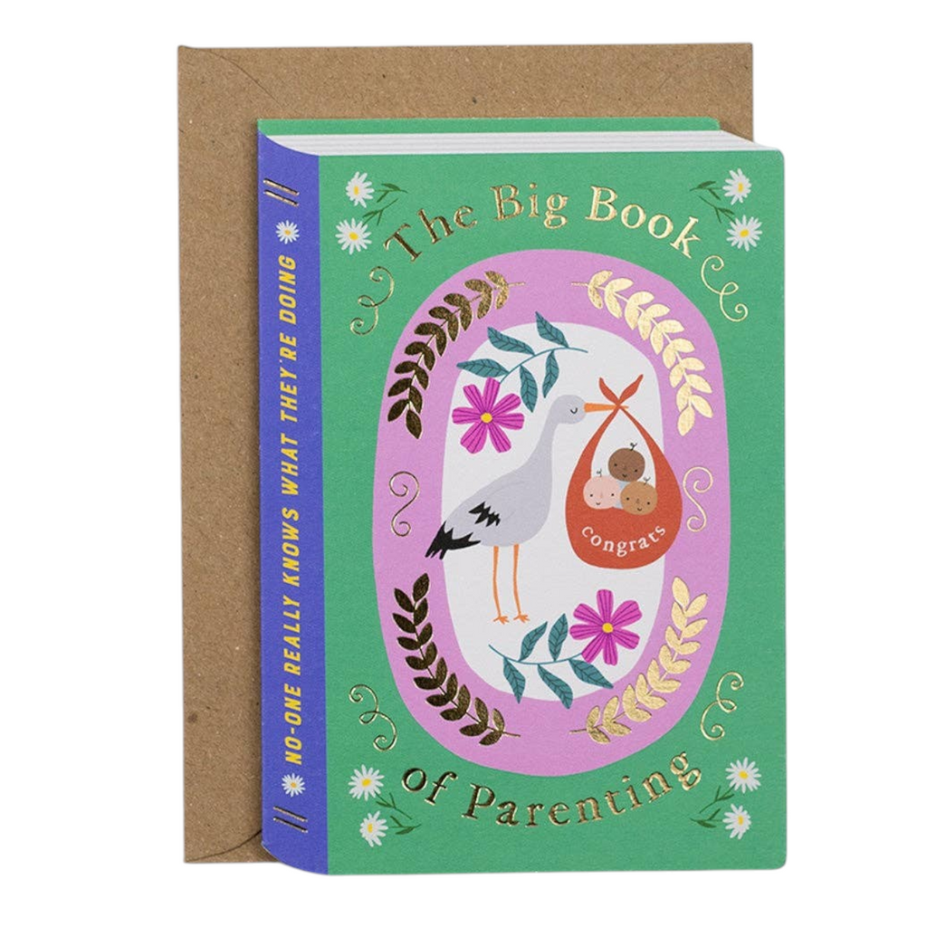 Mrs Best Paper Co. book-shaped new baby card with stork illustration and gold foil text on a kraft envelope.