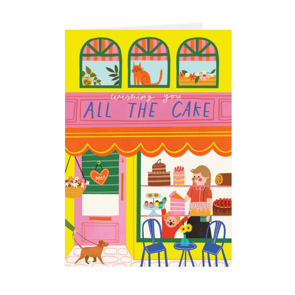 Mrs Best Paper Co. birthday card featuring a colourful illustration of a cake shop with a dog and a cat in the window.