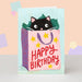 Mrs Best Paper Co. birthday card featuring a cute black cat peeking out of a pink gift bag with yellow stars