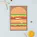 Mrs Best Paper Co. cheeseburger shaped birthday card with gold foil Happy Birthday text and recycled kraft envelope.