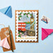 Mrs Best Paper Co. London travel-themed birthday card shaped like a stamp with gold foil details on a blue background.