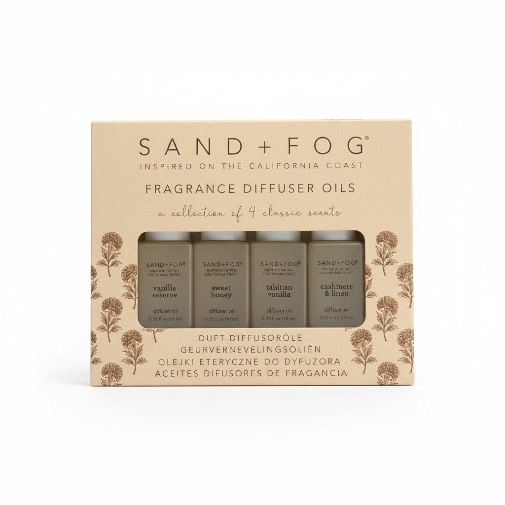 Mrs Best Paper Co. Sand + Fog 4-pack fragrance diffuser oils in vanilla, honey, and linen scents in a boxed set.