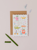Mrs Best Paper Co. scalloped baby card featuring whimsical mice in fruit-shaped vehicles with a kraft envelope.