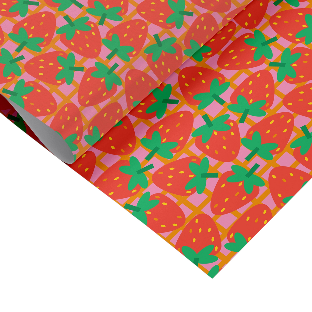 Mrs Best Paper Co. strawberry patterned gift wrap sheets with red fruit and green stems on a pink grid background.